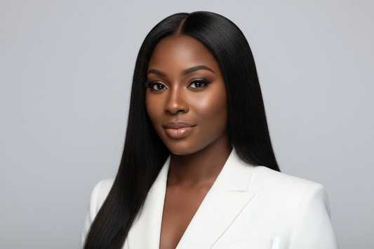 black gorgeous woman with long straight black hair. studio background. headshot. white suit
